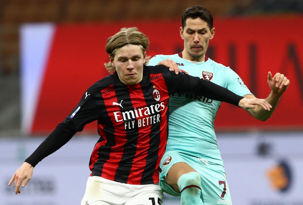 Jens Petter Hauge del Milan protegge palla su Lukic del Torino