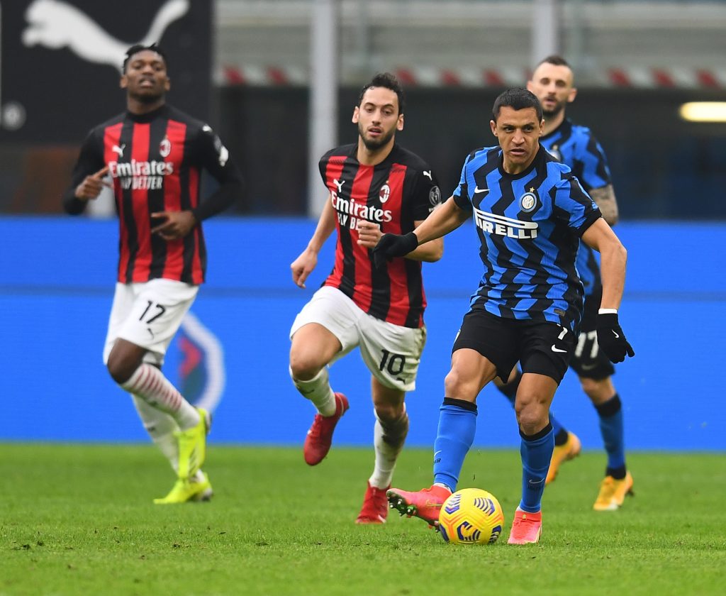 Alexis Sanchez dell'Inter inseguito da Calhanoglu del Milan