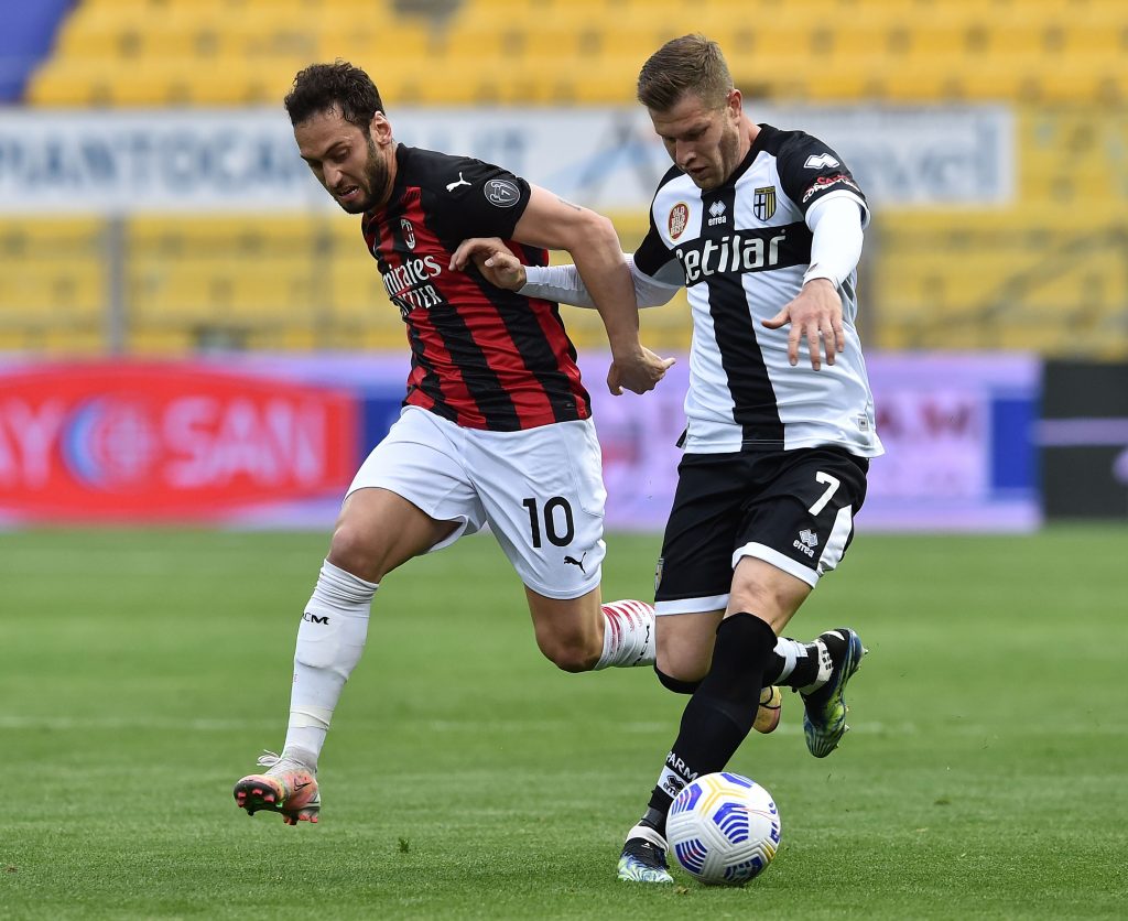 Hakan Calhanoglu del Milan a contrasto con Gagliolo del Parma